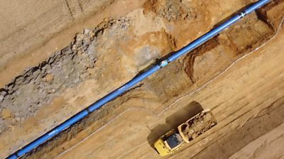 Pipeline installation trench Pipeline installation trench with blue pipe and soil representing infrastructure supply