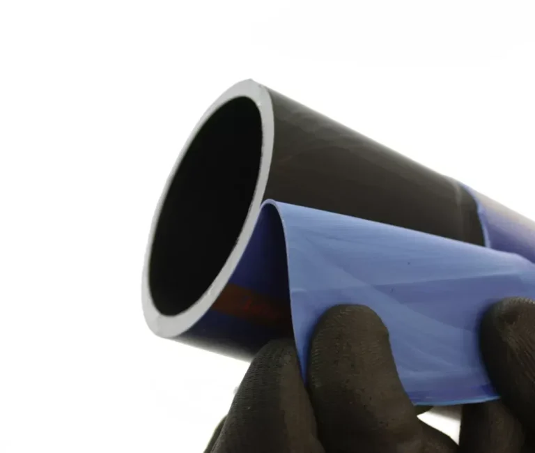 Profuse peelable water pipe A person with gloved hands peeling the outer layer from a plastic pipe.