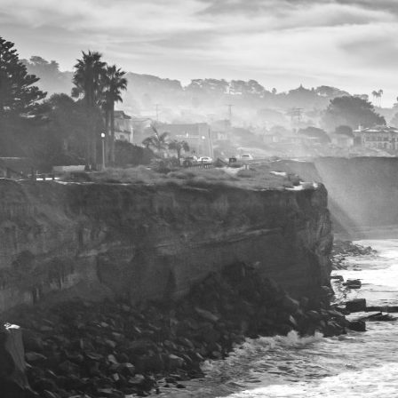 Coastal cliff representing offshore environment Black and white coastal cliff with palm trees representing offshore environment
