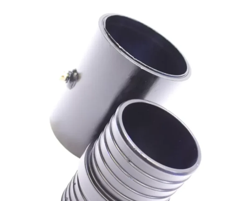 Redman fittings, for use with Puriton pipe Two cylindrical pipes, one smooth and the other with horizontal grooves.