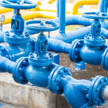Blue metal pipe fitting with a flange and bolts for secure attachment.